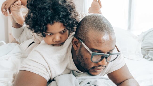 Dad working from home with young child